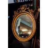 19th. C. gilt wood oval wall mirror. { 106cm H X 72cm W }.