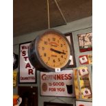 Hanging double sided clock advertising Connolly Station Dublin.