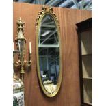 A pair of elliptical gilt mirrors with floral decoration 15" W x 54" H