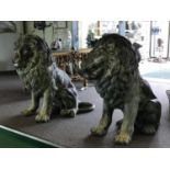 A spectacular pair of bronze green patinated seated lions 48" W x 52" H