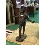 Fine bronze of a young boy holding a stick behind his back 32" W x 46" H