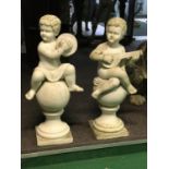 A fine set of vintage marble statues of seated cherubs playing instruments 40" H