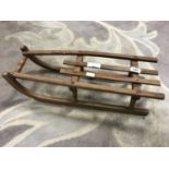 Vintage wooden child's sleigh and a collection of posters