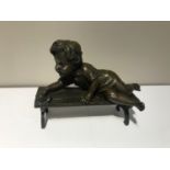 Bronze figure of a young girl playing with a snail on a bench 7" W x 3" D x 5" H