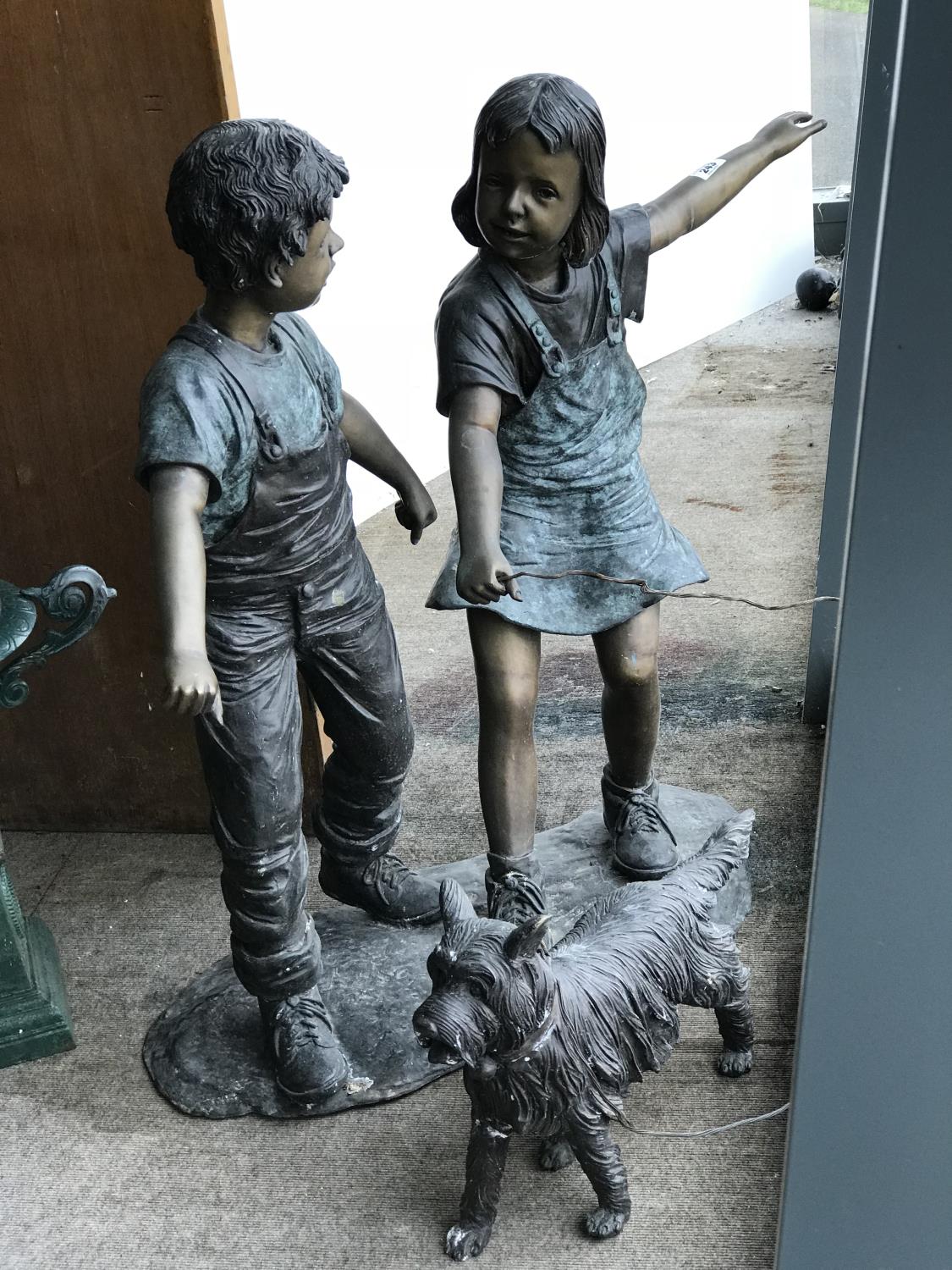 Unusual bronze sculpture of a boy and girl playing with a dog 46" W x 44" H