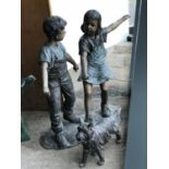 Unusual bronze sculpture of a boy and girl playing with a dog 46" W x 44" H