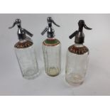 Three Thwaites glass soda siphons.