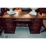 Mahogany pedestal desk with inset leather top in the Georgian manner.