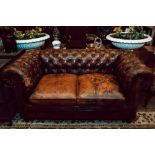 Good quality aged leather chesterfield two seater sofa.