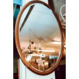 Edwardian mahogany oval wall mirror.