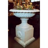 Pair of exceptional cast iron garden urns on pedestals.