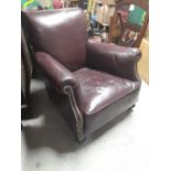 Early 20th C. leather easy chair on turned mahogany feet originally from the Hibernian Club Dublin.