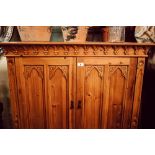 Carved stripped pine two door side cabinet.