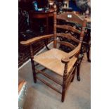 Late 19th. C. oak ladder backed chair with rush seat.