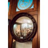 Edwardian oak convex wall mirror.