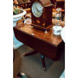 Georgian mahogany drop leaf table on four out swept legs and brass feet.