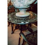 Decorative cast iron garden table and four chairs.