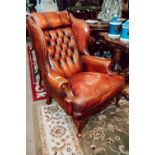 Pair of good quality ox blood leather chesterfield wing back chairs.