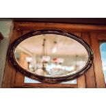 Edwardian Japanese lacquered oval wall mirror.