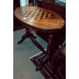 Edwardian inlaid walnut oval games table on turned support.