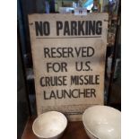 NO PARKING RESERVED FOR US CRUISE MISSILE LAUNCHER paper on card sign.