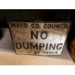 Cast alloy No Dumping road sign.