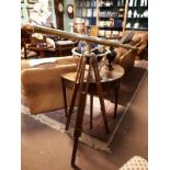 Brass telescope on mahogany tri pod base. (124 cm h x 114 cm w).