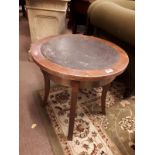 Pair of circular tables with leather tooled tops and four outwept legs. (54 cm h x 56 cm w)