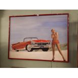 Framed painting of a Cadillac with female in foreground signed Alan Quigley '87.