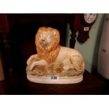 Pair of 19th. C. seated Staffordshire lions. (25 cm h x 28 cm w)