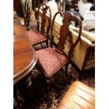 Set of ten mahogany dining room chairs with shaped backs and cabriole legs and upholstered seats.