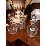 Set of three early 20th C. cut glass decanters.