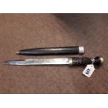 19th. C. Scottish dirk with ebony and silver handle and flowered blade with original leather