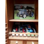 Two Fordson tractor signs and a Massey Ferguson tractor sign.