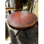 Regency style drum table with leather tooled top with three drawers in frieze.(76 cm h x 90 cm w).