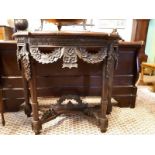 Decorative carved mahogany side table in the Rococo manner. (81 cm h x 98 cm w x 45 cm d).