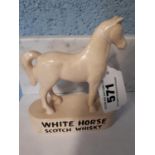 White Horse Scotch Whiskey advertising figure.