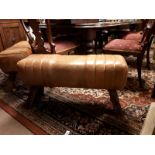 Pair of tanned leather pommel stools on four splayed legs. (87 cm l x 44 cm h)