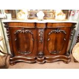 Very fine Victorian carved serpentine rosewood side cabinet the marble tops above two doors. (103 cm
