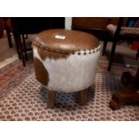 Leather and hide stool with four out swept legs. (46 cm h x48 cm W).