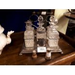 Early 20th C. silver plate and cut glass cruet set and a salt and pepper set.