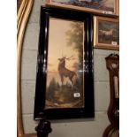 Pair of prints of stags in ebonised frames. (84 cm h x 43 cm w).