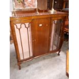 Art Deco mahogany display cabinet with one blind door flanked by two glazed doors.(130 cm x 119 cm w
