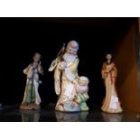 Three ceramic Oriental figures. (25 cm H) and (22 cm h).