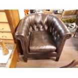 Leather button backed tub chair.