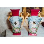 Pair of 19th. C. painted porcelain vases decorated with flowers and bird, with griffen handles. {