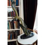 Art Deco model of a swooping eagle perched on a craggy rock mounted on a marble base - Rulas. { 78cm