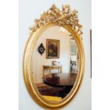 19th. C. giltwood oval wall mirror surmounted with quavers and leaves. { 122cm H X 84cm W }.