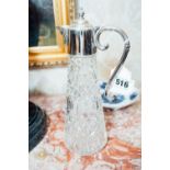 Cut glass claret jug with silver plated mounts. { 29cm H }.