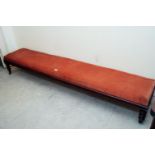 19th. C. upholstered mahogany bench with brass casters. { 40 cm H X 243cm L X 47cm D }.
